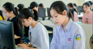 Young students diligently working on computers in a classroom, representing academic excellence and global learning through the Ban Ki-moon Global Citizen Scholarship.